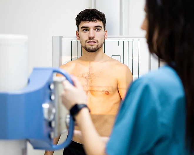 A man prepares to get a chest xray